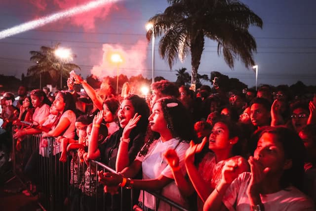 A street packed with dancers in colorful outfits, Cuban flags waving, and smoke rising from pastelito carts—Calle Ocho Festival in full salsa-fueled bloom.