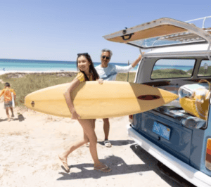 Children building a sandcastle on the beach in Panama City Beach, Florida with gentle Gulf waves in the background.