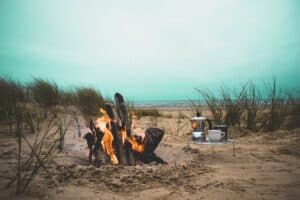 fire, flame, bonfire, campfire, beach, heat, firewood, grass, nature, sand, kitchenware, picnic, sea, ocean, water