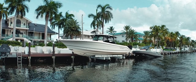 Boats docked along palm-lined canal at sunset in Cape Coral, Florida