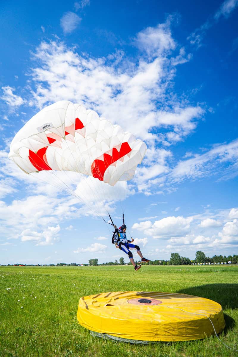 a person in the air with a parachute