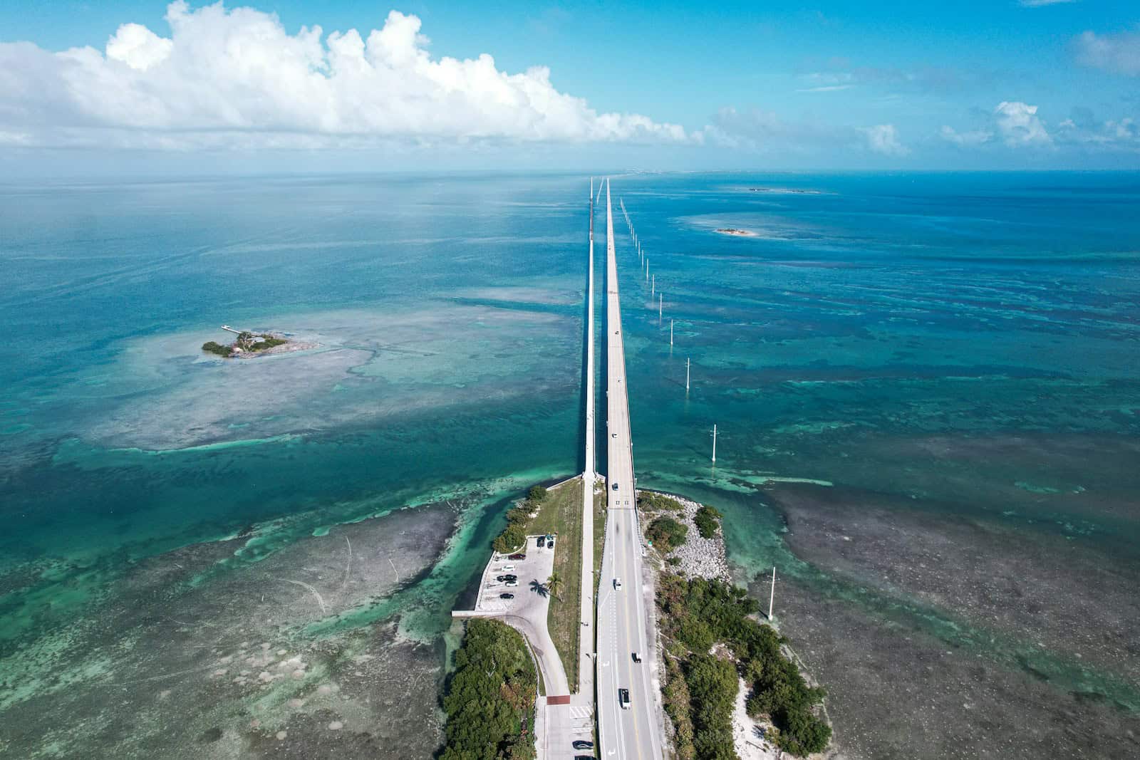 An aerial view of a road running through the ocean